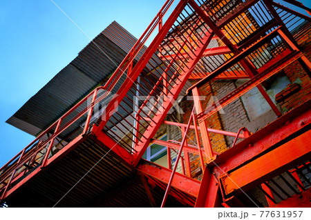 Staircase outside shabby brick building 77631957