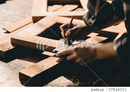 The carpenters high experienced wood worker making furniture. master of woodcraft male work with wooden handcraft piece with fine detail. The carpenters high experienced wood worker making furniture. master of woodcraft male work with wooden handcraft piece with fine detail. 77634151