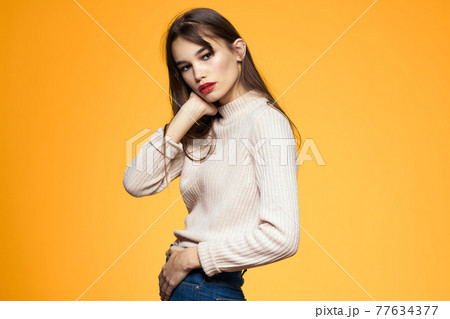 Cute brunette red lips fashionable clothes studio yellow background 77634377