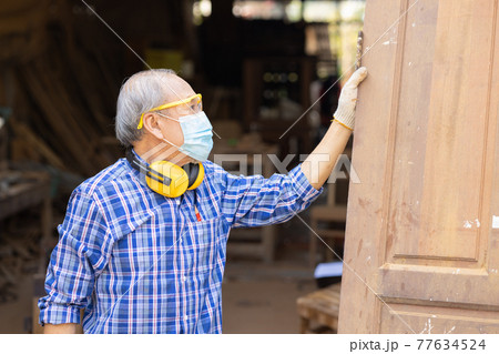 Elder worker wood woodcraft retire hobby for good retirement, Asian male mature professional master of making wooden furniture with face mask protective. Elder worker wood woodcraft retire hobby for good retirement, Asian male mature professional master of making wooden furniture with face mask protective. 77634524
