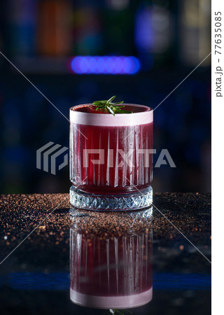 Red drink with ice and raspberrie juice 77635085