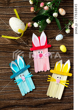 Easter bunny toy gift stics puppets on wooden table. Handmade. Project of children's creativity, handicrafts, crafts for kids. 77638645