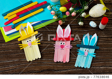 Easter bunny toy gift stics puppets on wooden table. Handmade. Project of children's creativity, handicrafts, crafts for kids. 77638646