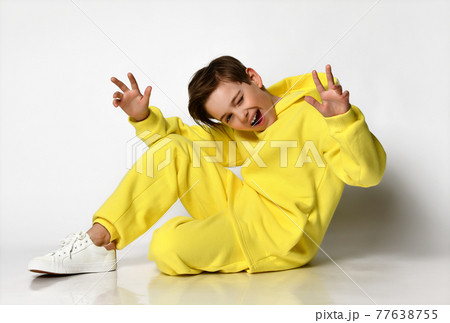Stylish active guy in a bright yellow sports suit 77638755