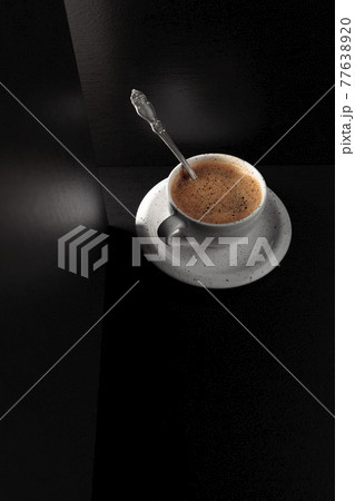 Black coffee on a black table. Black coffee on a black table. 77638920
