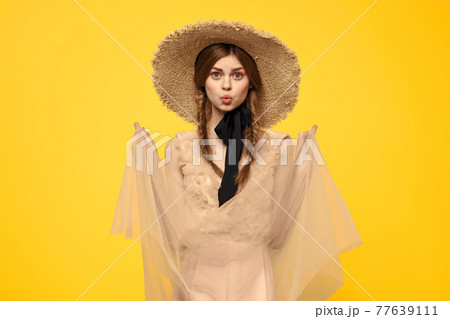 portrait of woman with red pigtails on yellow background cropped view emotion fun 77639111