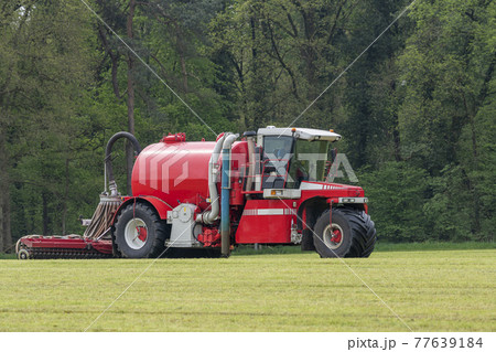 Injecting a freshly mowed lawn with a red injector . 77639184