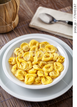 Italian Tortellini In broth on a plate. Italian Tortellini In broth on a plate. 77640187