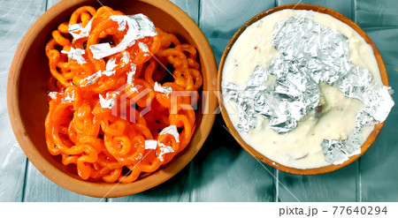 Kesari Jalebi/Jilbi with Rabdi is a delicious Indian recipe served as a Dessert in festivals or weddings. 77640294