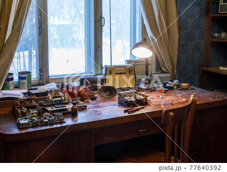 Wooden table littered with radio parts 77640392