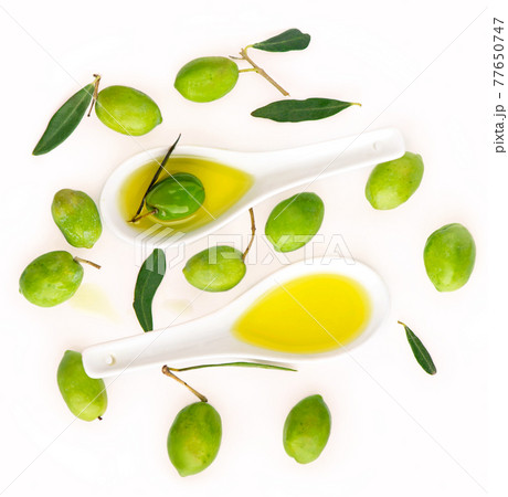 Olive fruit and olive leaves on a white background 77650747