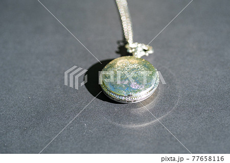 Pocket watch sovietic design shoot outside in a summer day closeup. Selective Focus 77658116