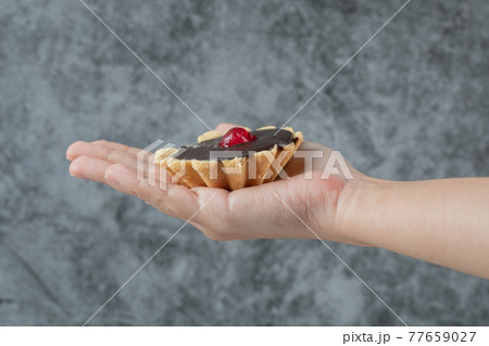 Holding crispy butter cookies in the hand 77659027