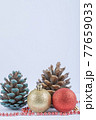 Christmas tree balls and oak cones with red pearl chain on the white background 77659033