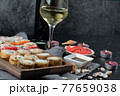 Mix sushi set with a glass of white wine 77659038