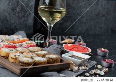 Mix sushi set with a glass of white wine Mix sushi set with a glass of white wine 77659038