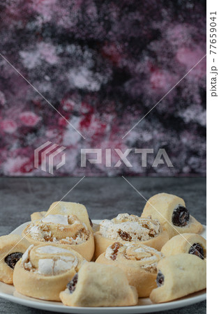 Butter cookies with sugar powder in a white ceramic plate 77659041