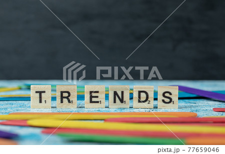 Trends writing with black letters on wooden dices on the blue background 77659046