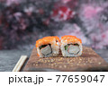 Sushi maki with red caviar and cream cheese on a wooden board 77659047