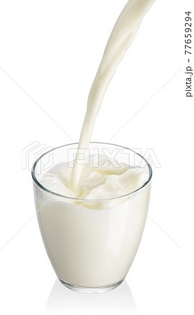milk pouring into glass isolated on white milk pouring into glass isolated on white 77659294
