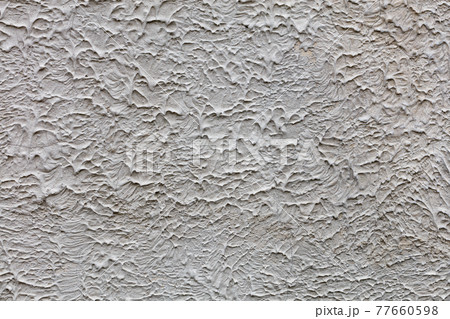 A gray textured wall covered with a frozen liquid concrete mixture, background and texture, close-up. A gray textured wall covered with a frozen liquid concrete mixture, background and texture, close-up. 77660598