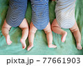 Newborn triplets boys lie on a stomach on a blanket 77661903