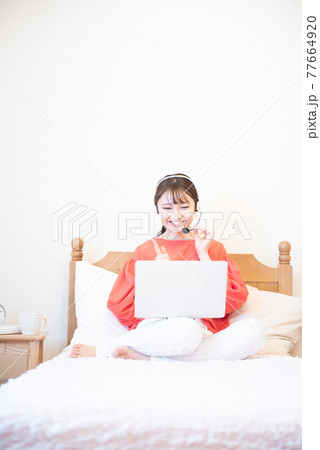 寝室　ノートパソコン　若い女性 77664920