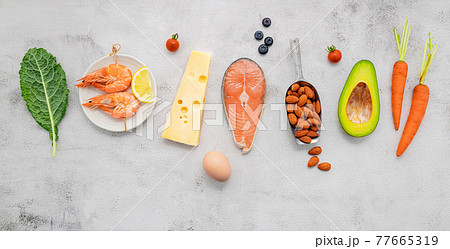 Ketogenic low carbs diet concept. Ingredients for healthy foods selection set up on white concrete background. Ketogenic low carbs diet concept. Ingredients for healthy foods selection set up on white concrete background. 77665319
