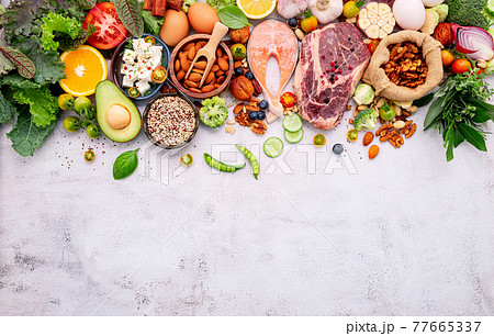 Ketogenic low carbs diet concept. Ingredients for healthy foods selection set up on white concrete background. Ketogenic low carbs diet concept. Ingredients for healthy foods selection set up on white concrete background. 77665337