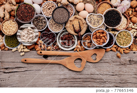 Ingredients for the healthy foods selection in ceramic bowl. The concept of superfoods set up on white shabby wooden background with copy space. 77665346