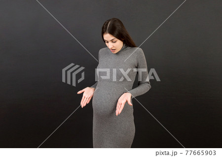 happy surprised pregnant woman posing isolated over colored background. copy space happy surprised pregnant woman posing isolated over colored background. copy space 77665903