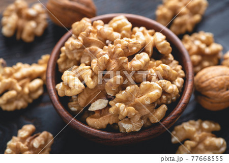 Peeled walnuts in bowl 77668555