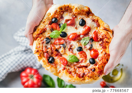 Homemade pizza in male hands 77668567