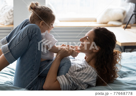 Happy mom relax play with toddler daughter Happy mom relax play with toddler daughter 77668778