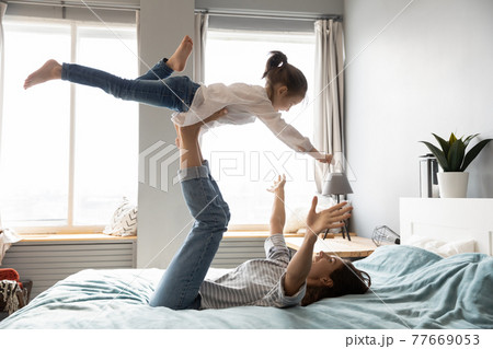 Happy mom have fun play with little daughter 77669053