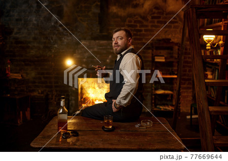Man smokes a cigar, tobacco smoking culture Man smokes a cigar, tobacco smoking culture 77669644