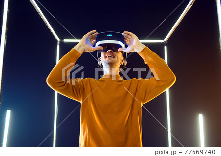 Male gamer using virtual reality headset Male gamer using virtual reality headset 77669740