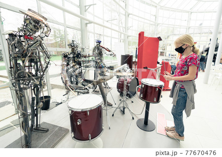 girl in medicine mask playing drum 77670476