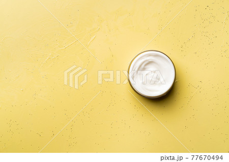 Cream for skin on yellow 77670494