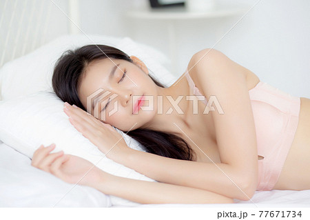 Beautiful asian young woman in underwear sleep lying on bed with comfort and happy leisure. 77671734