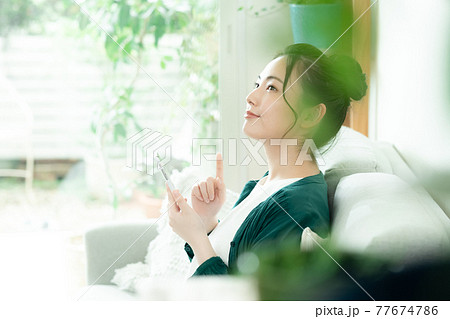 スマホを見る若い女性 77674786