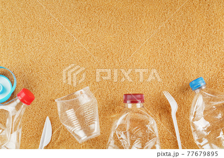 Plastic trash on a sandy beach with Trash from plastic bottles on a sandy beach with free space. Plastic trash on a sandy beach with Trash from plastic bottles on a sandy beach with free space. 77679895