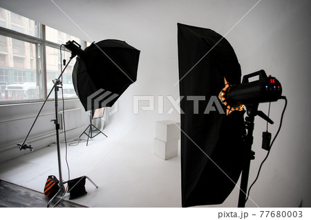 Photo studio, lighting fixtures, white endless background, white cubes. Professional studio equipment. Photo studio, lighting fixtures, white endless background, white cubes. Professional studio equipment. 77680003