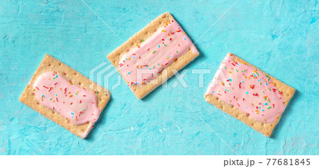 Pop tarts flat lay panorama on a blue background Pop tarts flat lay panorama on a blue background 77681845