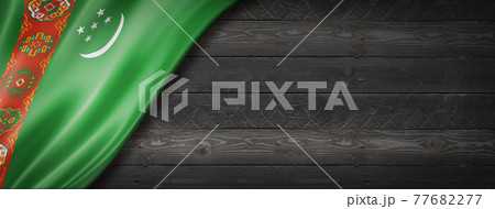 Turkmenistan flag on black wood wall banner Turkmenistan flag on black wood wall banner 77682277