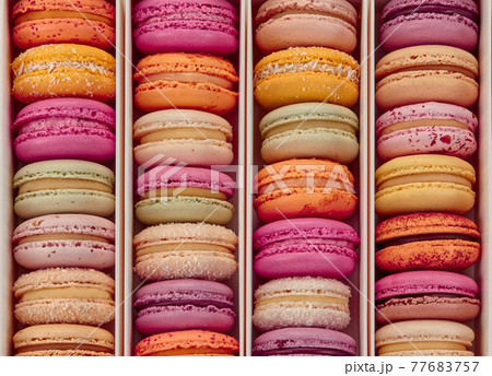 Top view of colorful macarons in rows in box 77683757