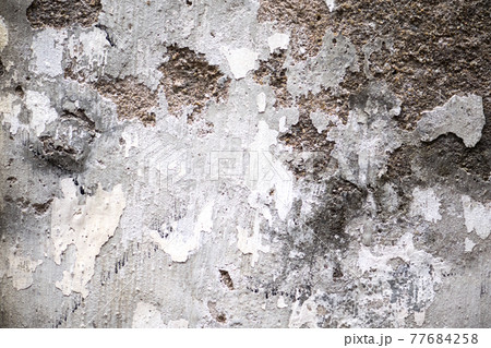 Layered wall erosion with bricks. Texture of an old brick wall. Layered wall erosion with bricks. Texture of an old brick wall. 77684258