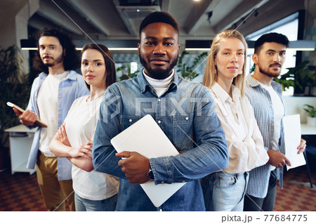 Group portrait of five diverse young colleagues standing in a row in office Group portrait of five diverse young colleagues standing in a row in office 77684775