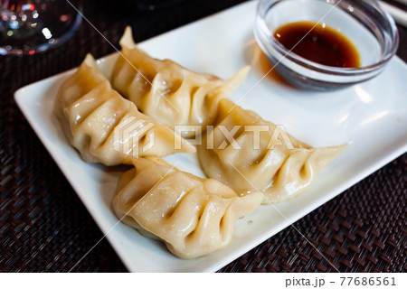 Japanese tasty dumplings gyozas with soy sauce Japanese tasty dumplings gyozas with soy sauce 77686561
