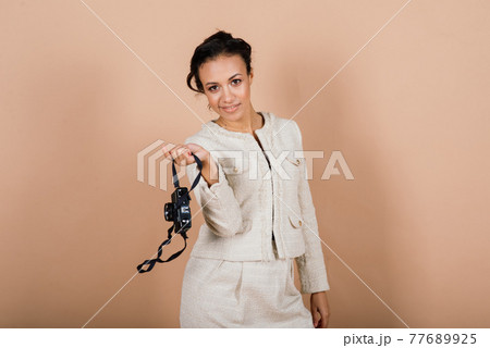 Attractive african american black female, using a slr digital camera taking photographs in studio. 77689925